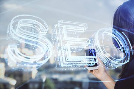 Double exposure of SEO sketch hologram and woman holding and using a mobile device.の写真素材