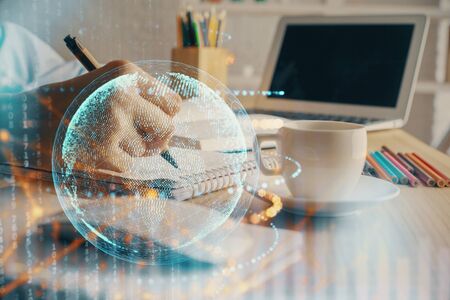 Double exposure of hands making notes with world map hologram and data theme icons. Concept of international network data.の写真素材