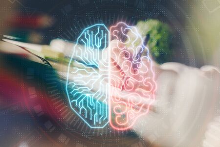 Multi exposure of writing hand on background with brain hologram. Concept of self learning.