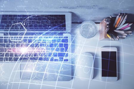 Double exposure of map hologram drawing over study table background with computer. Concept of...