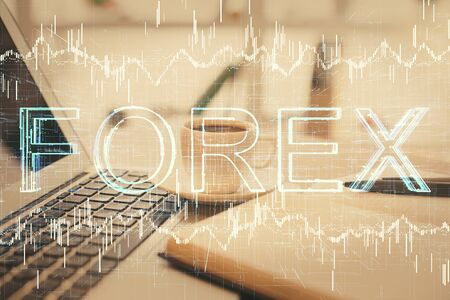 Double exposure of financial chart drawing and desktop with coffee and items on table background. Concept of forex market tradingの写真素材