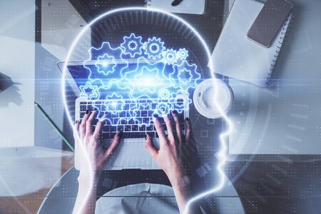 Double exposure of woman working on computer andhuman brain hologram drawing. Top View. Ai concept.