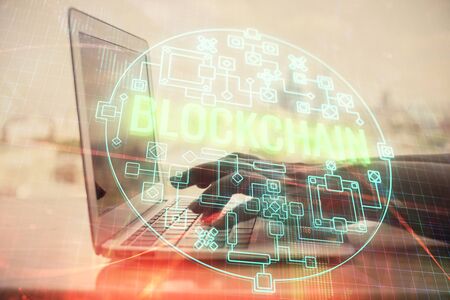 Double exposure of woman hands typing on computer and crypto market theme hologram drawing. Blockchain concept.の写真素材