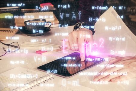 Double exposure of mans hands holding and using a phone and formulas drawing. Education concept.