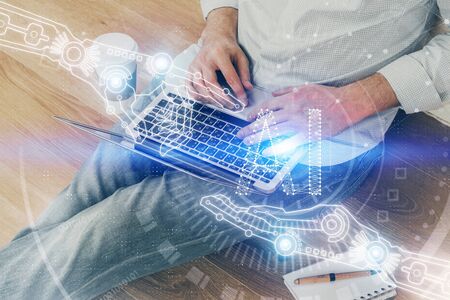 Multi exposure of data internet theme hologram with man working on computer on background. Concept...