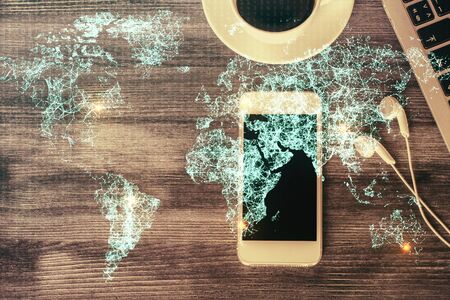 Double exposure of social network theme drawing over table with phone. Top view. People connecting concept.の写真素材