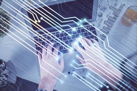 Double exposure of mans hands typing over computer keyboard and data theme hologram drawing. Top...
