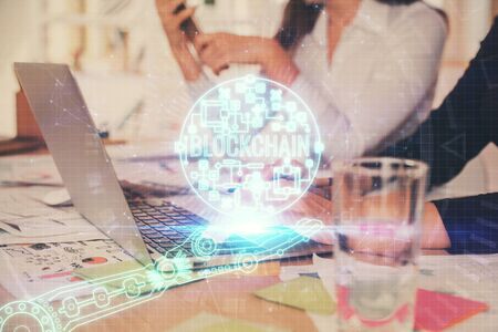 Double exposure of woman hands typing on computer and crypto market theme hologram drawing....