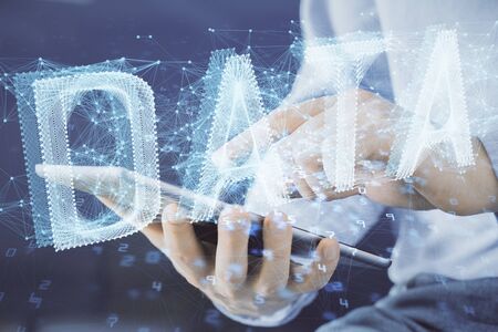 Multi exposure of mans hand holding and using a digital device and data theme drawing. Innovation...