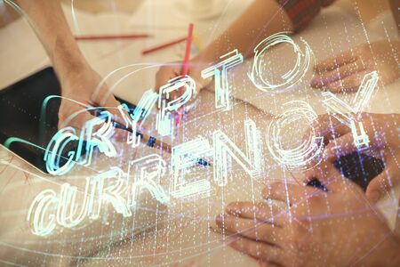 Double exposure of crypto theme drawing and man and woman working together holding and using a mobile device. Blockchain concept.の写真素材