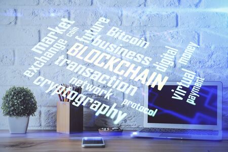 Multi exposure of blockchain and crypto economy theme hologram and table with computer background. Concept of bitcoin cryptocurrency.の写真素材
