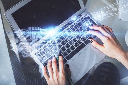 Double exposure of woman working on computer andhuman brain hologram drawing. Top View. Ai concept.