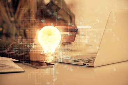Multi exposure of woman on-line shopping holding a credit card and bulb drawing. Choice concept.の写真素材