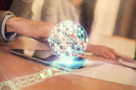 Double exposure of crypto theme drawing and man and woman working together holding and using a mobile device. Blockchain concept.の写真素材