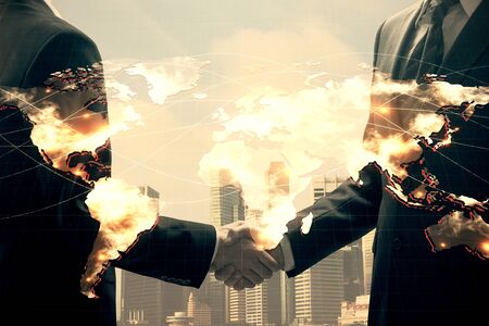 Double exposure of business theme hologram and handshake of two men. Success concept.の写真素材