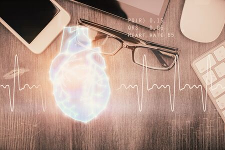 Double exposure of heart drawing over table with phone. Top view. Medical education concept.の写真素材