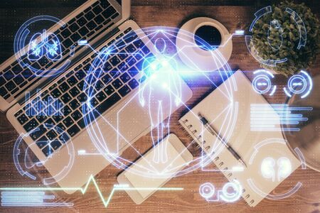 Education hologram drawings over computer on the desktop background. Top view. Multi exposure.の写真素材