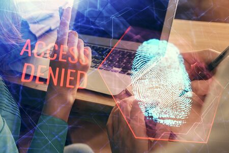 Double exposure of man and woman working together and fingerprint hologram drawing. Security concept. Computer background.の写真素材