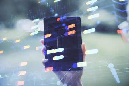 Double exposure of technology sketch hologram and woman holding and using a mobile device. Ai...