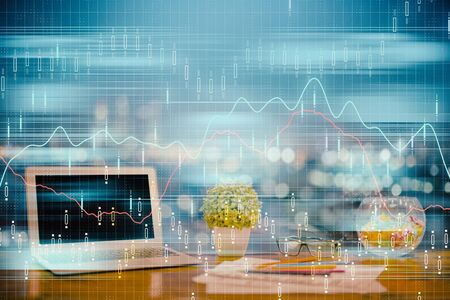 Forex graph hologram on table with computer background. Double exposure. Concept of financial...