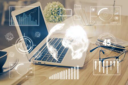 Financial chart drawing and table with computer on background. Multi exposure. Concept of international markets.の写真素材