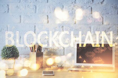 Multi exposure of blockchain and crypto economy theme hologram and table with computer background. Concept of bitcoin cryptocurrency.の写真素材