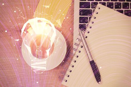 Bulb drawing over computer on the desktop background. Top view. Double exposure. Idea concept.の写真素材