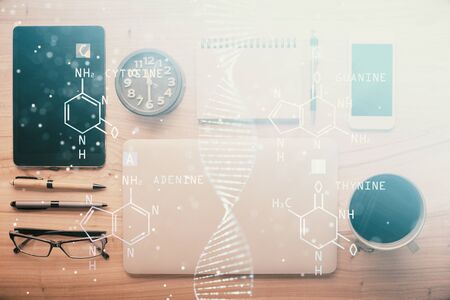 Double exposure of DNA drawing over table with phone. Top view. Science education concept.の写真素材