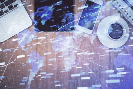 Double exposure of technology theme drawing over work table desktop. Top view. Global data analysis concept.の写真素材