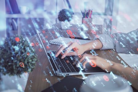 Double exposure of woman hands working on computer and data theme hologram drawing. Tech concept.の写真素材