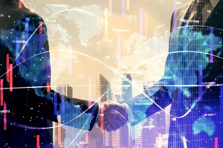 Double exposure of business theme hologram and handshake of two men. Success concept.の写真素材