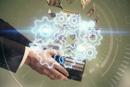 Multi exposure of financial theme drawing hologram and USA dollars bills and man hands. Business...