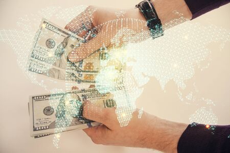 Multi exposure of financial theme drawing hologram and USA dollars bills and man hands. Business concept.の写真素材