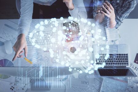 Double exposure of man and woman working together and human brain hologram drawing. Brainstorm...