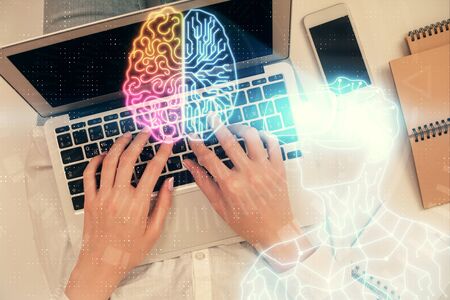 Double exposure of woman hands working on computer and man in ar glasses hologram drawing. Top View. Virtual reality concept.の写真素材