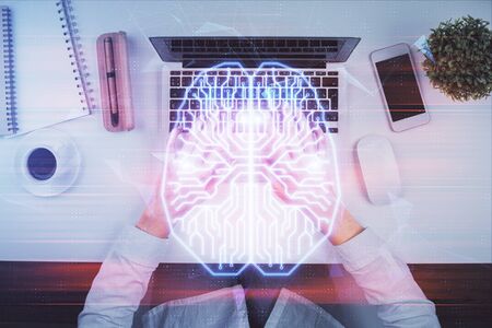Double exposure of woman working on computer andhuman brain hologram drawing. Top View. Ai concept.の写真素材
