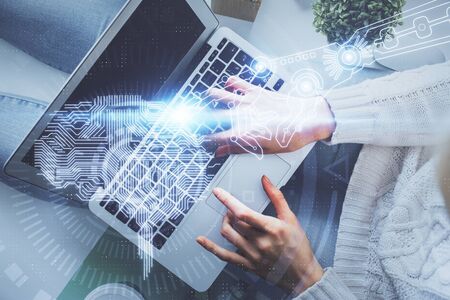 Double exposure of woman working on computer andhuman brain hologram drawing. Top View. Ai concept.