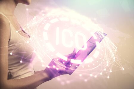 Double exposure of blockchain business sketch hologram and woman holding and using a mobile device.の写真素材