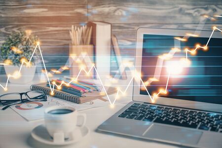 Forex market chart hologram and personal computer background. Multi exposure. Concept of investment.