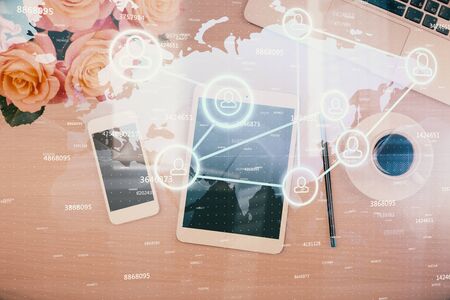 Double exposure of social network theme drawing over table with phone. Top view. People connecting concept.の写真素材