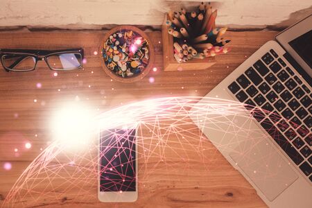 Double exposure of social network theme drawing over table with phone. Top view. People connecting concept.の写真素材