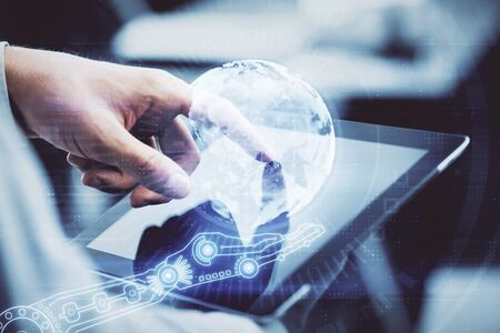 Multi exposure of mans hands holding and using a digital device and map drawing. International...