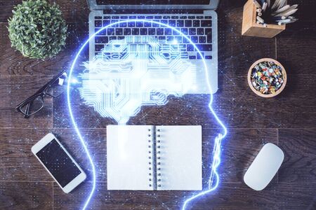 Double exposure of brain drawing hologram over topview work table background with computer. Concept...