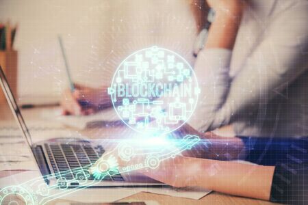Double exposure of woman hands typing on computer and crypto market theme hologram drawing....