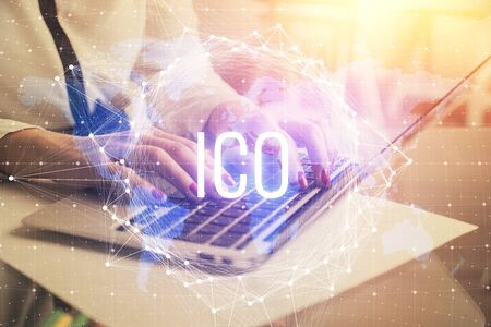 Double exposure of woman hands typing on computer and crypto market theme hologram drawing. Blockchain concept.の写真素材