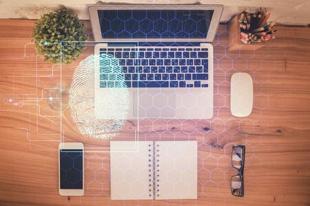 Finger print over computer on the desktop background. Top view. Double exposure. Concept of securitization.の写真素材