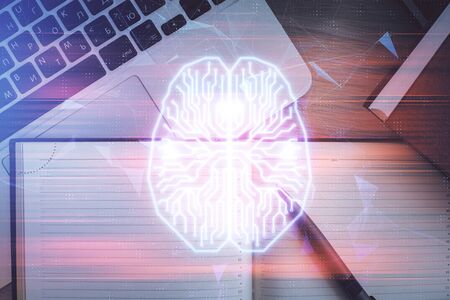 Double exposure of brain drawing hologram over topview work table background with computer. Concept...