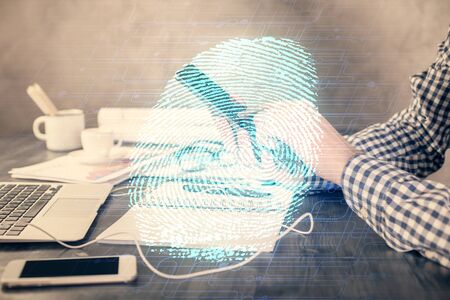 Double exposure of mans hands holding and using a digital device and fingerprint hologram drawing....