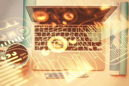 Technology hologram drawing over computer on the desktop background. Top view. Double exposure. Tech concept.のeditorial素材