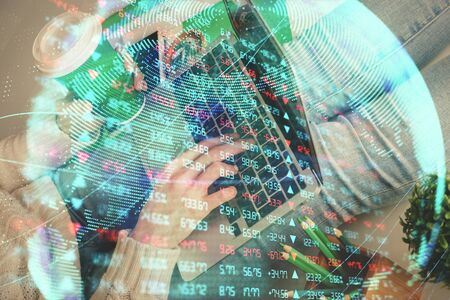 Double exposure of woman hands typing on computer and business theme hologram drawing. Success concept.の写真素材